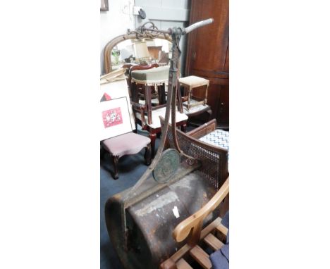 A large cast iron garden roller, supplied by "Harrods Ltd London"