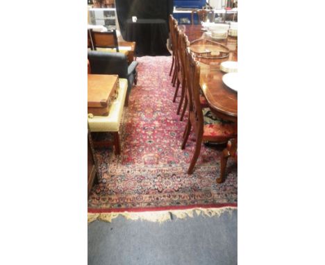 A large red ground Persian design carpet, with all over floral decoration, circa 120" x 180" (plus fringes)