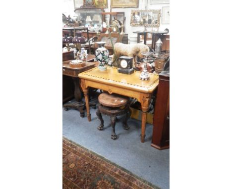 A Victorian light oak Gothic style fold over top card table with inset ebonised parquetry decoration, the baize with tooled l