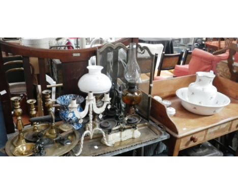 A Victorian oil lamp with cast iron foot, another similar, a collection of candlesticks, metalware and similar items