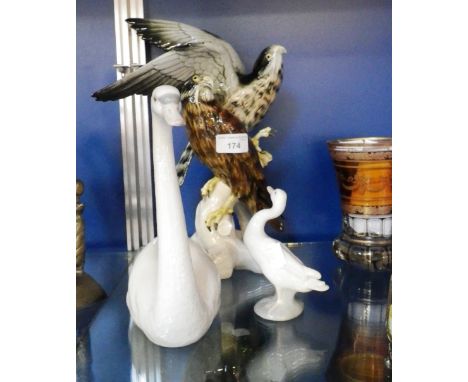 A ceramic ornament of two birds of prey and two similar ornaments