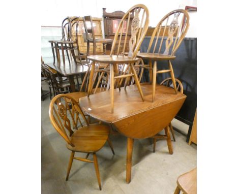 An Ercol Golden Dawn elm and beech drop-leaf table and four chairs 