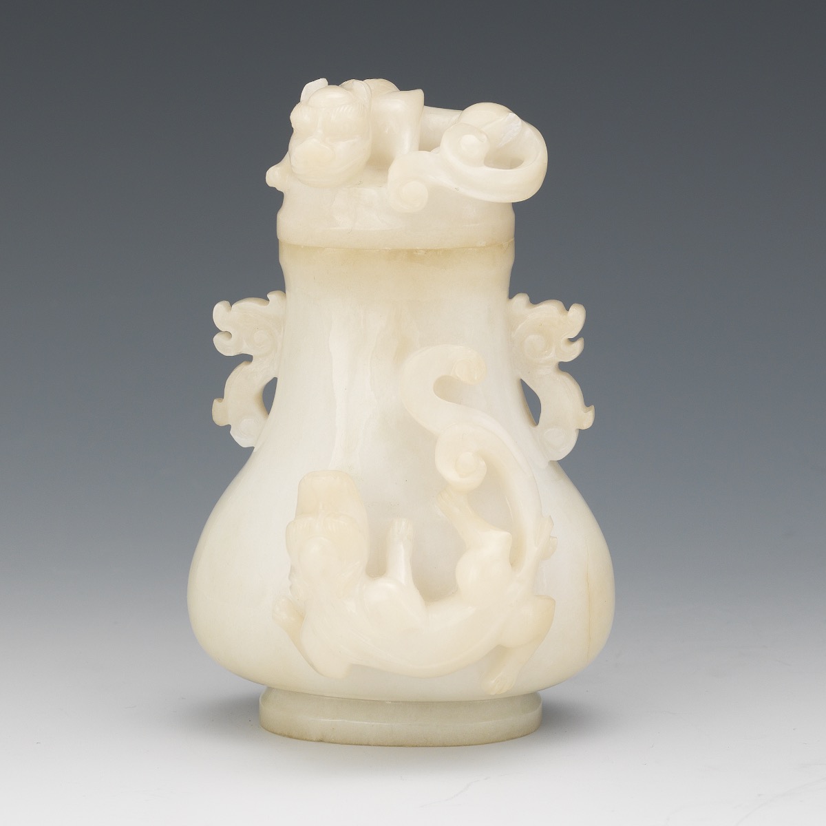 5" x 31/4" x 23/4" Carved white lidded jade vase of slightly