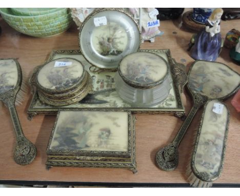 A dressing table set gilt and black pierced metal design with oriental decoration, includes clock