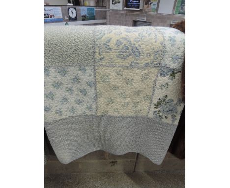 A vintage style patchwork bed spread