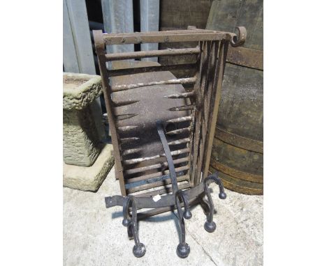 A vintage cast fire grate, coat hooks and carriage lamps