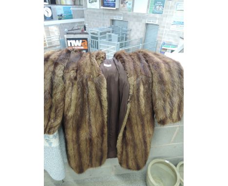 A 3/4 length mink coat with a shawl collar
