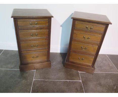 A pair of late Victorian or Edwardian walnut bedside chests each with four graduated drawers with swan neck handles, possible