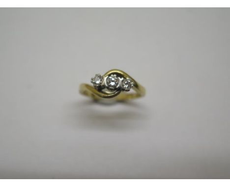 A hallmarked 18ct yellow gold three stone diamond crossover ring, size K, approx 3 grams, some wear but generally good and di