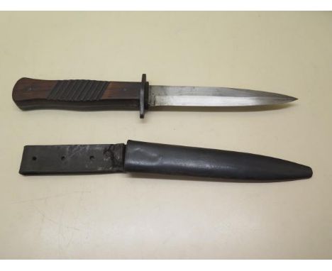 A WWI German trench knife with scabbard, some denting to scabbard but generally good condition 