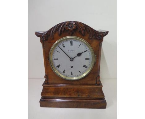 An 8 day walnut table clock by J.Caney Cheapside London with a fusee movement, 33cm tall, running, some wear and cracking to 