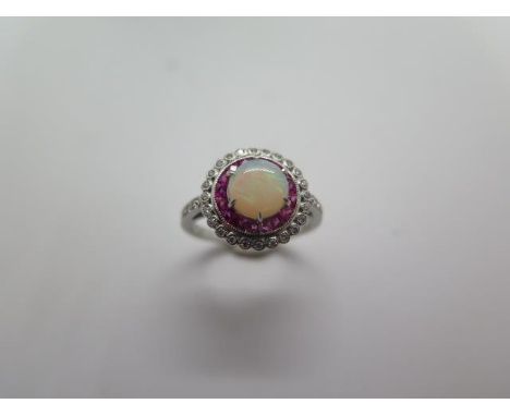 A platinum opal, ruby and diamond ring, hallmarked, size M, head approx 12mm, approx 5 grams, in good condition 