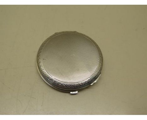 A silver compact. Cohen and Charles. 2.1 troy oz. Condition- some surface dings to base and a few graze marks there and top. 