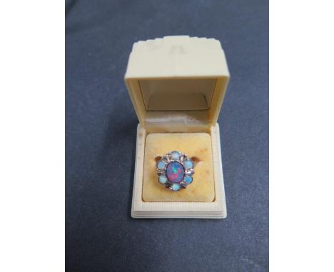 A 9ct yellow gold Australian lightening ridge opal ring in original Australian casecraft Art Deco bakelite ring box, size I/J