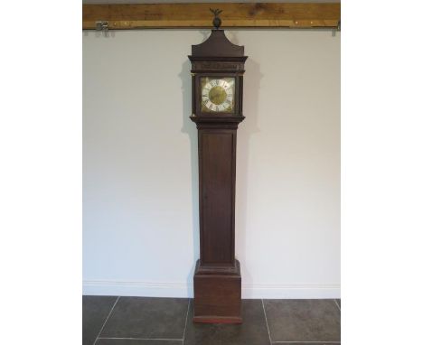 An oak carved 30 hour single hand longcase clock, the dial signed Wm Russell Wootton, with a 8" square dial, standing 83" tal