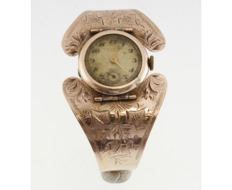 An unusual 9ct ladies bangle wristwatch with engraved decoration, the dial signed 'B.W.CANEY, DURBAN' the working movement si