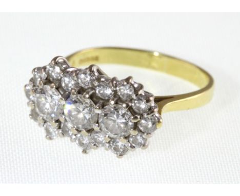 An 18ct diamond cluster ring, the three centre round brilliant cut stones approx 0.33ct each, approx total diamond weight 1.5