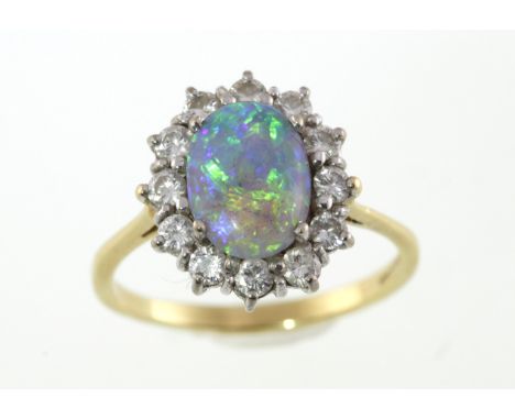 An 18ct H/M fiery opal & diamond cluster ring, approx total diamond weight 0.75cts & 5.3gms, size S