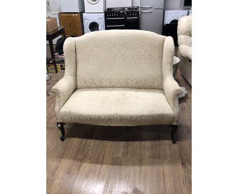 A WING BACK QUEEN ANNE STYLE TWO SEATER SOFA WITH CABRIOLE LEGS