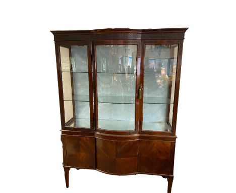 Edwardian Chippendale revival bow breakfront display cabinet, blind fret frieze above three glazed doors with two glass shelv