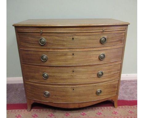 C19th bow front mahogany dressing chest, with brushing slide above four long graduated cockbeaded drawers with brass ring han