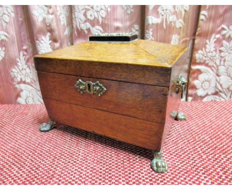 C19th oak sarcophagus shaped two division tea caddy, with brass cartouche, handle and paw feet, W21cm D15cm H19cm 