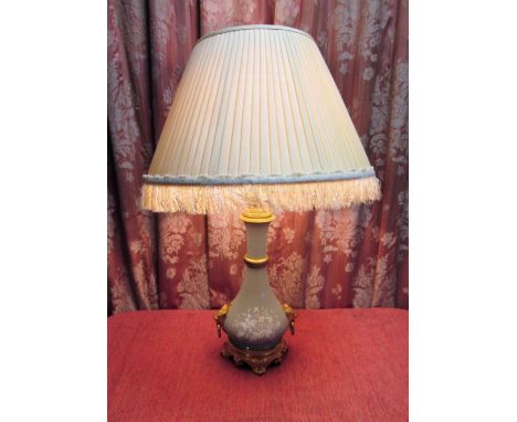 French table lamp, the pâte-sur-pâte bottle shaped body with ormolu base, lion mask and ring handles and  fringed shade, H50c
