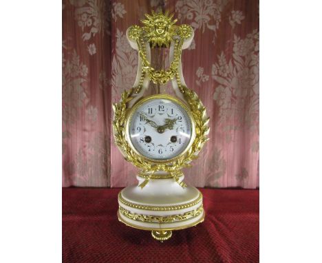 C20th French ormolu mounted alabaster lyre shaped mantel clock, drum movement with convex Arabic dial enclosed by ribbon tied