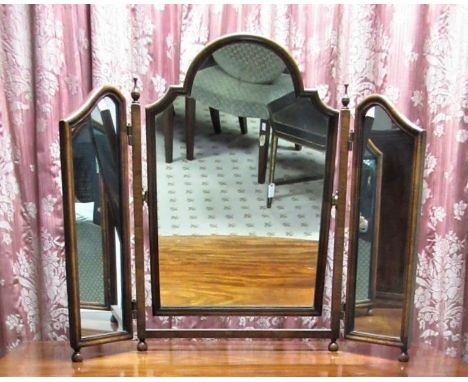 Queen Anne style walnut triptich dressing table mirror with arched plates on square frame with  turned finials and ball feet,