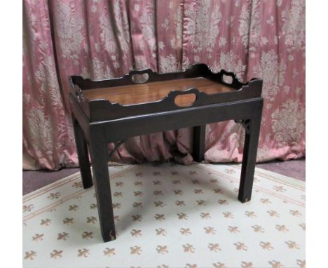 Chippendale style mahogany tray topped table, galleried top with pierced handles on blind fret carved supports with corner an