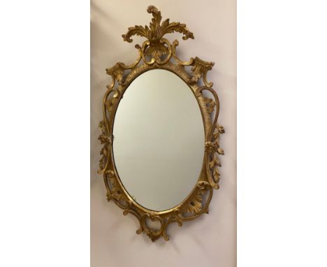 C20th Chippendale style wall mirror, oval plate in C scroll and floral carved frame with acanthus leaf cresting W56cm H94cm 