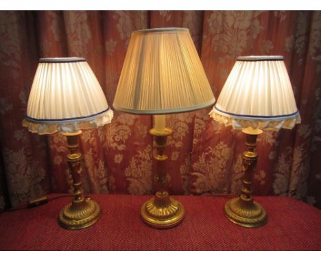 Pair of early C20th French gilt metal candlestick table lamps with urn shaped sconces on fluted tapering column supports and 