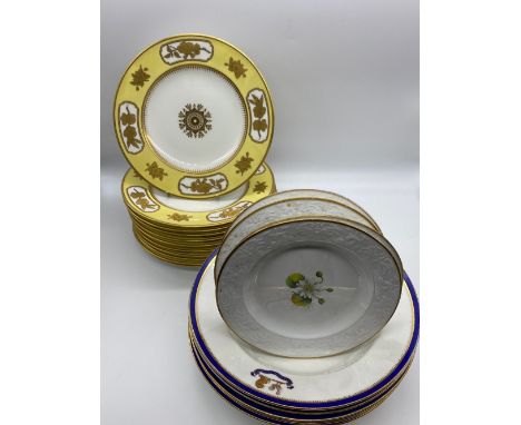 Set of four Spode circular plates, painted to centre with wild flower sprays on a white ground, with relief decorated border 