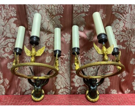 Pair of French Empire style cast and gilt metal three light wall brackets, the urn shaped sconces supported by a winged cheru