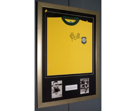 A facsimile Brazil International football shirt, signed by Pele, in glazed gilt frame, with certificate of authenticity verso