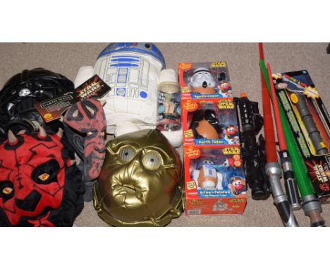 Three Star Wars Mr. Potato Head sets, in boxes; Star Wars backpacks; toy light sabres; and other Star Wars related toys.