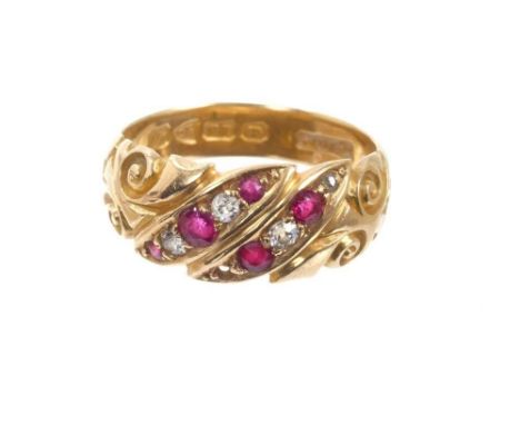 Early 20th century 18ct gold ring set with rubies and diamonds with carved gold scroll shoulders, Chester 1912. Ring size N½.