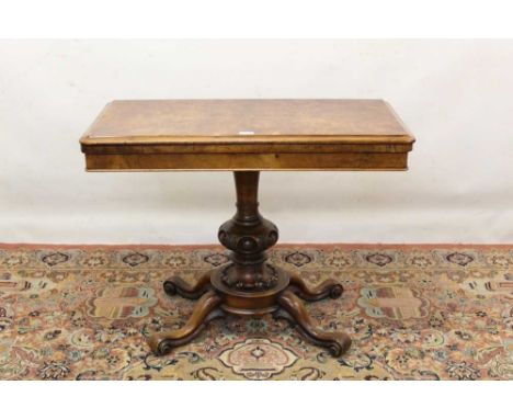 Victorian burr walnut card table, rounded rectangular fold-over top with baize lined interior, raised on carved knopped colum