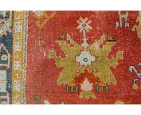 Rare Turkish Ushak type carpet, central brick red field with scattered foliate motifs within multiple geometric borders, 370 