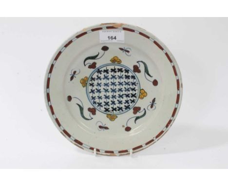 Unusual 18th century continental Delftware dish, probably Dutch, polychrome painted with foliate patterns, and a central cros