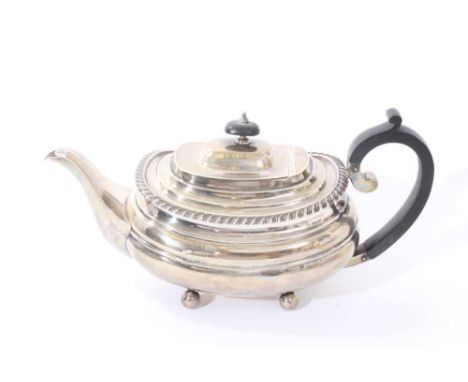 1940s silver teapot of compressed baluster form, with gadrooned border, angular ebony handle and hinged domed cover, with ebo