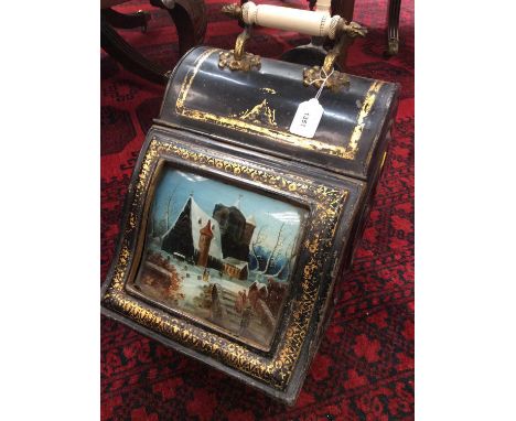 19th century tôleware painted coal purdonium, the hinged cover with inset painted wintry scene, surmounted by ceramic carryin