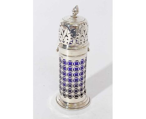 Edwardian silver sugar caster of lighthouse form, with pierced daiperwork decoration, blue glass liner and pierced bayonet fi