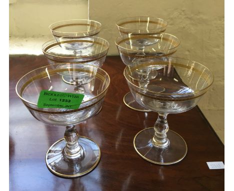 A set of six ealy 20th Century champagne saucers with gilt decoration.