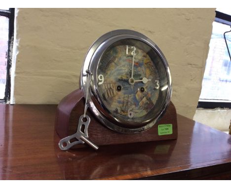 A 'Ships Through the Ages' ship style mantle clock on mahogany base