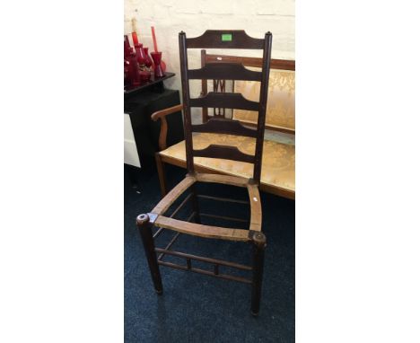 An early 20th Century oak ladder back Clissett style chair, lacking rush seat.