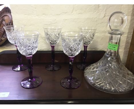 A group of 5 Bohemian cut glass hock glasses on purple stems with cut glass ships decanter.