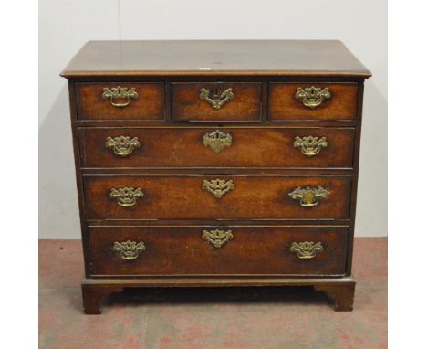 18th century oak chest of three short and three long drawers, on bracket feet, with later brass handles and mounts, 96cm high