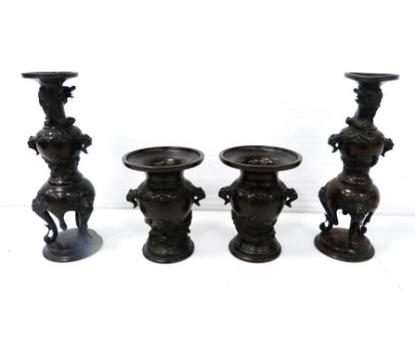 Pair of Japanese patinated bronze urn-shaped flaring vases (Meiji period, 1868 - 1912), with mask surmounts above relief drag