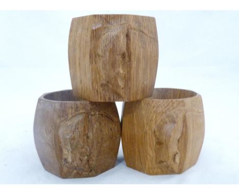 Workshop of Robert 'Mouseman' Thompson of Kilburn Three oak octagonal napkin rings, all bearing trademark carved mouse, 5cm h